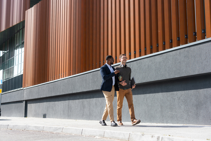 Colleagues walking outside a modern building