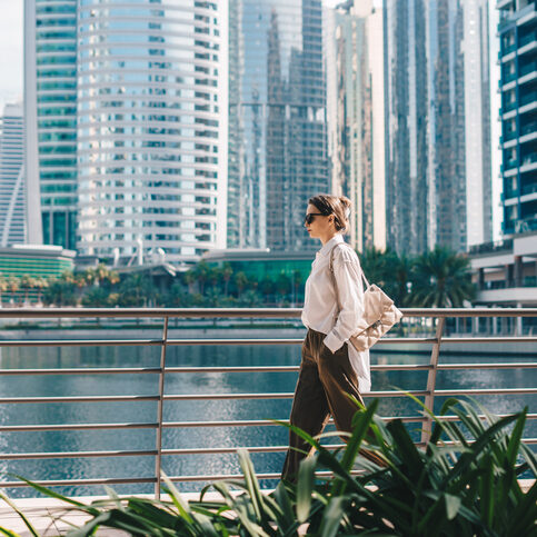 Woman walking with modern city background