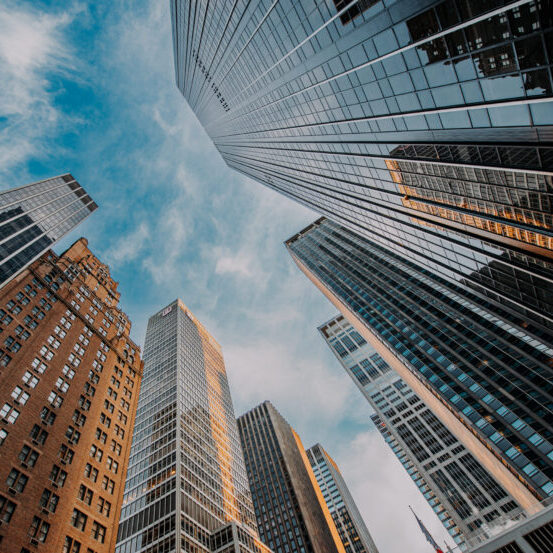 Commercial high-rise office towers viewed from street level in an urban financial district