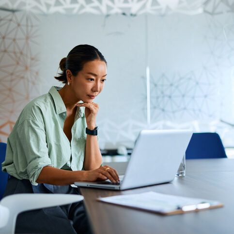 Businesswoman working on laptop in modern office